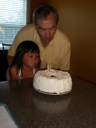 Kasen and Papa blowing out birthday candles